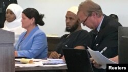 Defense attorney Thomas Clark, right, sits next to his client, defendant Siraj Ibn Wahhaj, defense attorney Marie Legrand Miller, second left, and her client Hujrah Wahhaj, left, during a hearing on charges of child abuse in which they were granted bail in Taos County, New Mexico, Aug. 12, 2018.