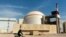FILE - A worker rides a bicycle past the Bushehr nuclear power plant, just outside the southern city of Bushehr, Oct. 26, 2010. The official IRNA news agency reported, Feb. 1, 2024, that Iran is building four more new power plants in the port town of Sirik on the east coast.