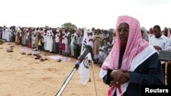 Senior al-Shabab officer Sheikh Hassan Dahir Aweys leads faithful in prayers on the first day of Eid al-Adha in Somalia's capital Mogadishu November 6, 2011.