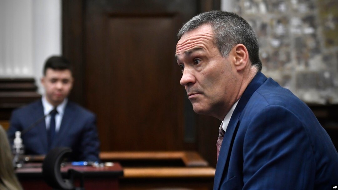 Kyle Rittenhouse, left, looks on as his attorney Mark Richards questions him as he testifies during his trial at the Kenosha County Courthouse, in Kenosha, Wisconsin, Nov. 10, 2021. 
