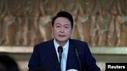 File - South Korea’s new President Yoon Suk Yeol speaks during the 20th Presidential inaugural reception in Seoul. “Our government will respond firmly and sternly to any North Korean provocation,” he said Monday during a ceremony to mark South Korea’s Memorial Day. 