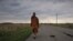 Buddhist monk Sutham Nateetong walks along the road outside Arcola, IN. June 8, 2019.