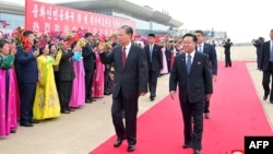 This picture released by the Korean Central News Agency shows China's Zhao Leji, left, an official high in the Communist Party hierarchy, walking with Choe Ryong Hae, right, chairman of North Korea's Standing Committee of the Supreme People's Assembly, at the Pyongyang airport.