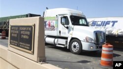 A truck crosses the border between Mexico and the United States in Nuevo Laredo, Mexico.