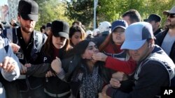 Police detain a protester after an explosion in southeastern Turkish city of Diyarbakir, early Nov. 4, 2016. 