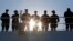 FILE - U.S. Navy personnel line the rails at Naval Station Norfolk, in Norfolk, Virginia, Dec. 18, 2018.