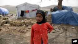 A displaced girl stands outside her family's hut at a camp for internally displaced people in the outskirts of Sanaa, Yemen, May 27, 2016. Yemen's war has killed at least 6,200 civilians and injured tens of thousands of Yemenis, and 2.4 million people hav