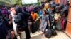 FILE - Rohingya refugees collect aid supplies including food and medicine, sent from Malaysia, at Kutupalang Unregistered Refugee Camp in Cox’s Bazar, Bangladesh, Feb. 15, 2017.