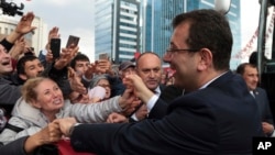 Cheering supporters try to touch Ekrem Imamoglu, the main Turkish opposition's candidate for Istanbul, after he visited the mausoleum of Mustafa Kemal Ataturk, the secular republic's founder, in Ankara, Turkey, Tuesday, April 2, 2019.