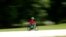 A child rides a bicycle in a park which reopened after several weeks of closure, in Milan, Italy, May 4, 2020.