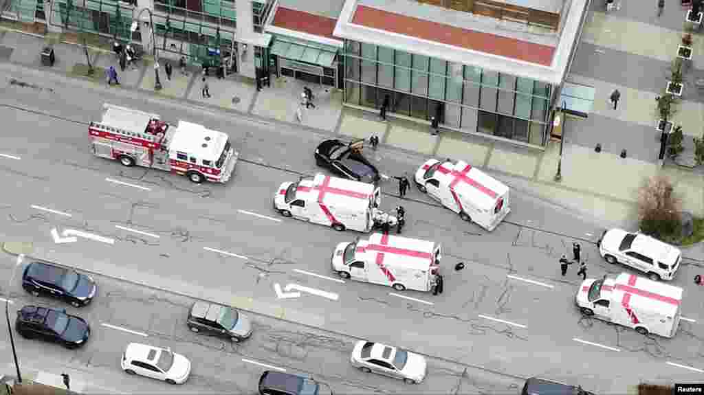 Ambulances and emergency personnel are seen on a road outside Lynn Valley Main Library, where police said multiple people were stabbed by a suspect who was later taken into custody, in North Vancouver, Canada, March 27, 2021, in this still image from video