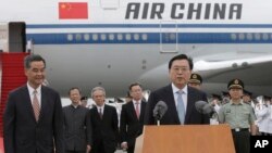 The chairman of the Standing Committee of China's National People's Congress, Zhang Dejiang (R), speaks to the media next to Hong Kong's Chief Executive CY Leung (L) after arriving at Hong Kong's airport, May 17, 2016. Authorities rolled out a massive secu