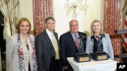 Secretary Clinton presents the World Food Program's 2011 George McGovern Leadership Award to Howard Buffett and Bill Gates, at the Department of State; also pictured is WFP Executive Director Josette Sheeran.