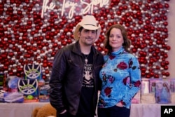 Brad Paisley, left, and Kimberly Williams-Paisley pose for a picture at The Toy Store on December 7, 2023, in Nashville, Tennessee. (AP Photo/Mark Humphrey)