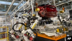 Nissan’s “intelligent factory” hardly has any human workers. The robots do the work, including welding and mounting in the assembly line at Nissan's Tochigi plant in Kaminokawa town Oct. 8, 2021. (AP Photo/Yuri Kageyama)