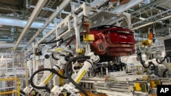 Kaminokawa town, Tochigi prefecture, Japan, Friday, Oct. 8, 2021. Nissan’s “intelligent factory” hardly has any human workers. The robots do the work, including welding and mounting. They do the paint jobs and inspect their own paint jobs. (AP Photo/Yuri 