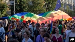 People carry a rainbow flag during a pride march in Belgrade, Serbia, Sept. 7, 2024.