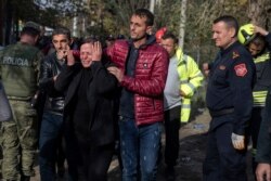 A woman mourns after rescuers found the body of a relative after an earthquake in Thumane, western Albania, Nov. 27, 2019.