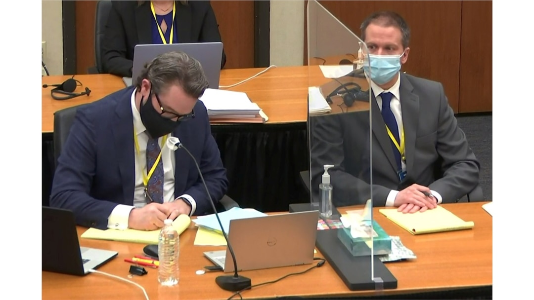 Former Minneapolis police officer Derek Chauvin attends the eleventh day of his trial, with his defense attorney Eric Nelson, in Minneapolis, Minnesota, April 12, 2021, in a still image from video.