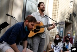 FILE - Jonathan Wasserman, left, and Adam Masser perform the Tishrei Niggun, a sacred Jewish melody, during the Faiths for Climate Justice global mobilization event organized by the GreenFaith International Network on Oct. 17, 2021, at Hebrew Tabernacle synagogue in New York.