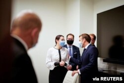 FILE - Belarusian opposition leader Sviatlana Tsikhanouskaya meets with French President Emmanuel Macron in Vilnius, Lithuania, Sept. 29, 2020.