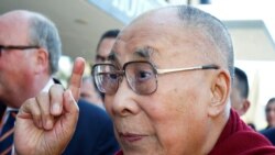FILE PHOTO: Tibetan spiritual leader the Dalai Lama gestures as he arrives at a hotel in Darmstadt, Germany, Sept. 18, 2018.