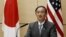 Japan's Chief Cabinet Secretary Yoshihide Suga speaks during a joint media briefing about the process of U.S. forces consolidation in Okinawa, in Tokyo, Dec. 4, 2015.