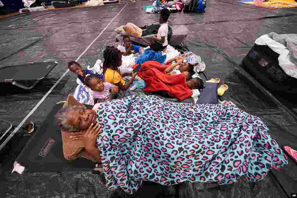 Vera Kelly of Tallahassee lies on a cot after evacuating to a hurricane shelter with her grandchildren and great grandchildren, at Fairview Middle School, ahead of Hurricane Helene, in Leon County, Florida.