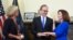New York Chief Judge Janet DiFiore, left, swears in Kathy Hochul, right, as the first woman to be New York's governor while her husband Bill Hochul holds a bible during a swearing-in ceremony at the state Capitol, Aug. 24, 2021, in Albany, N.Y. 