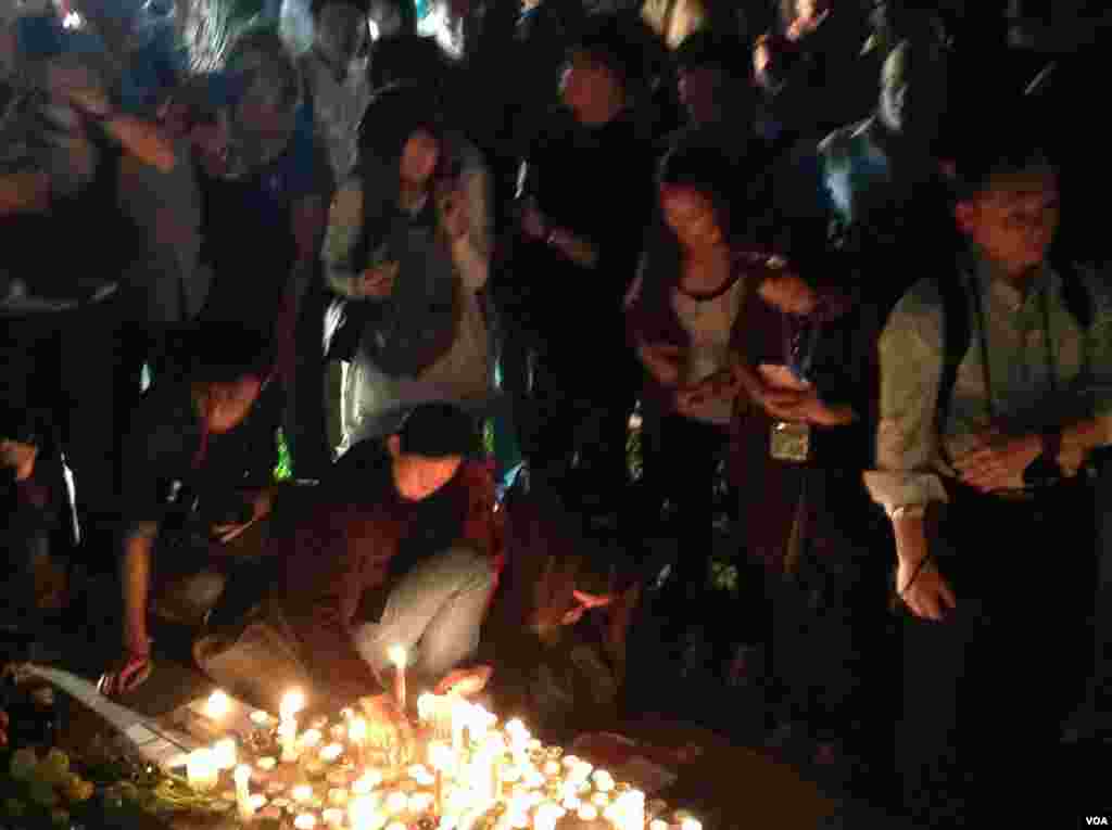 Students use candles to form a large ribbon during an event to mark World AIDS Day at a primary school in Hohhot, Inner Mongolia autonomous region, China.