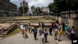 FILE - People visit the archeological site Valongo Wharf, the main port of entry for enslaved Africans to Brazil and the Americas, in Rio de Janeiro, Brazil, Nov. 13, 2021. Brazil received more slaves from Africa than any other place. 