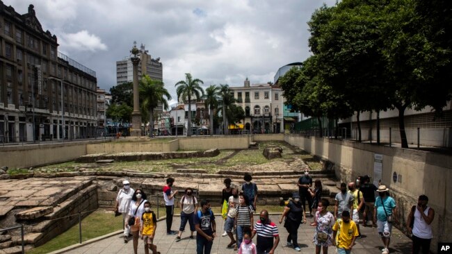 FILE - People visit the archeological site Valongo Wharf, the main port of entry for enslaved Africans to Brazil and the Americas, in Rio de Janeiro, Brazil, November 13, 2021.
