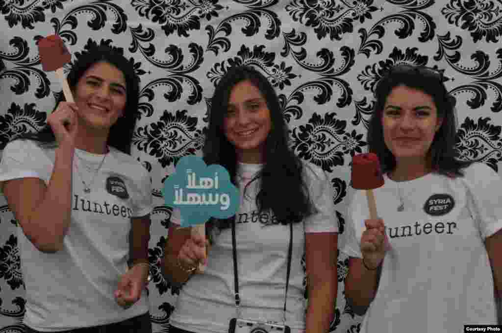 Syria Fest volunteers pose in pop-up photo booth in Washington, Sept. 3, 2017. The booth featured cards to help teach participants the Syrian dialect. (Photo courtesy of Rabah Seba)