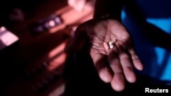 FILE - Guillermo Habanero, 56, a kidney transplanted patient, shows his medicines at his house in Caracas, Venezuela, Feb. 7, 2018. 