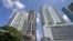 A high-rise building under construction is shown next to high-rise condominium buildings, Sept. 7, 2017, in downtown Miami.