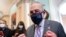 Senate Majority Leader Chuck Schumer, D-N.Y., emerges from a lengthy Democratic Caucus meeting as the Senate continues to grapple with end-of-year tasks at the Capitol in Washington, Dec. 16, 2021.