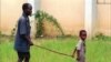 FILE - A child leads a man affected by river blindness in Gbarnga, Liberia, Sept. 4, 1995. Hospitals in Cameroon are reporting an increase in cases of the disease in 2023, which is caused by bites from infected blackflies. 