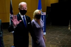 FILE - Democratic presidential candidate former Vice President Joe Biden walks to an outdoor stage with his wife Jill Biden during the fourth day of the Democratic National Convention, at the Chase Center in Wilmington, Delaware, Aug. 20, 2020.