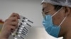 CHINA -- A worker inspects syringes of a vaccine for COVID-19 produced by Sinovac at its factory in Beijing, September 24, 2020.