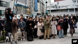 Bystanders pray at 2:46 p.m., March 11, 2025, in Tokyo, as Japan marked the 14th anniversary of the 2011 earthquake, tsunami, and nuclear disaster that devastated the northeastern coast. 