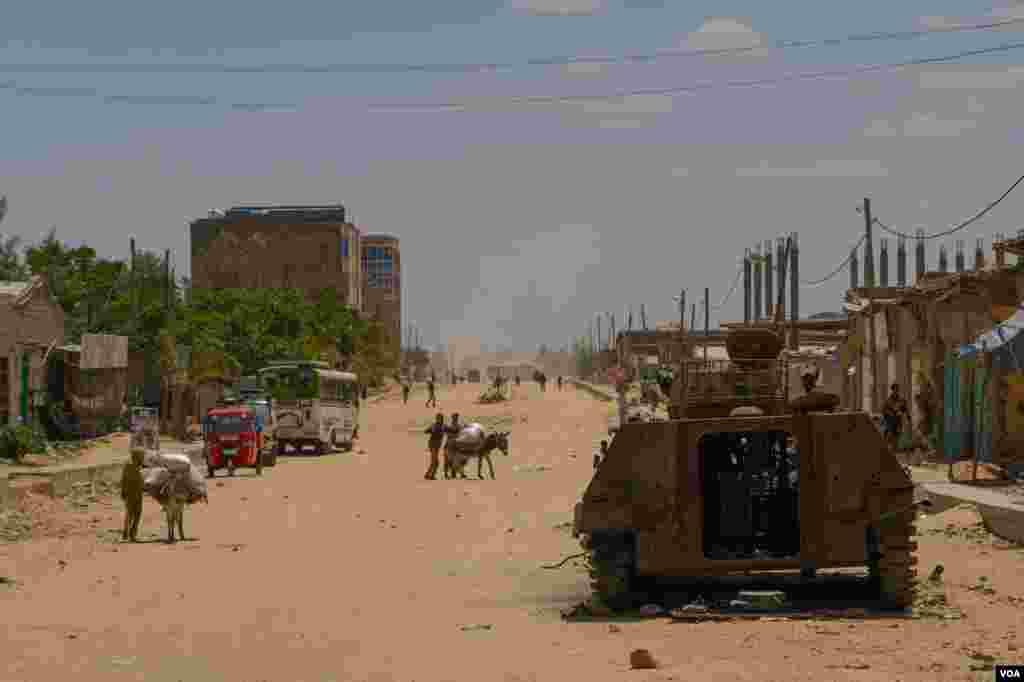 A destroyed armored vehicle lays in one of the mains streets of Hawzen, a small town in the frontline of the war in Tigray, Ethiopia, on June 6, 2021. (VOA/Yan Boechat) 