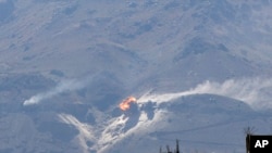 An explosion is seen following a Saudi-led airstrike hit a site believed to be one of the largest weapons depots on the outskirts of Yemen's capital, Sana'a, Oct. 15, 2015. 