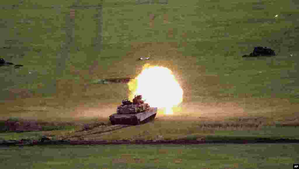 A U.S. M1A2 Abrams tank fires during a joint military exercise at Vaziani military base, outside Tbilisi, Georgia.