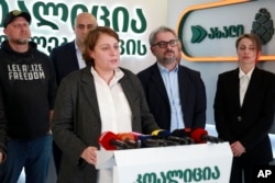 Elene Khoshtaria, chair of United National Movement, center, speaks to the media at the coalition's headquarters after the parliamentary election in Tbilisi, Georgia, Oct. 27, 2024.