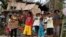 Children hold signs asking for help and food along the highway, after Typhoon Haiyan hit Tabogon town in Cebu Province, central Philippines November 11, 2013.
