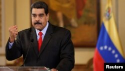 FILE - Venezuela's President Nicolas Maduro gestures as he talks to the media during a news conference in Caracas, Venezuela, Feb. 15, 2018.