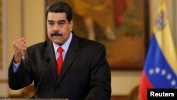 FILE - Venezuela's President Nicolas Maduro gestures as he talks to the media during a news conference in Caracas, Venezuela, Feb. 15, 2018.