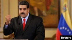 Venezuela's President Nicolas Maduro gestures as he talks to the media during a news conference in Caracas, Venezuela, Feb. 15, 2018.