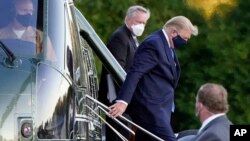 President Donald Trump arrives at Walter Reed National Military Medical Center, in Bethesda, Md., Oct. 2, 2020, on the Marine One helicopter after he tested positive for COVID-19. 