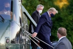 President Donald Trump arrives at Walter Reed National Military Medical Center, in Bethesda, Maryland, Oct. 2, 2020, on the Marine One helicopter after he tested positive for COVID-19.